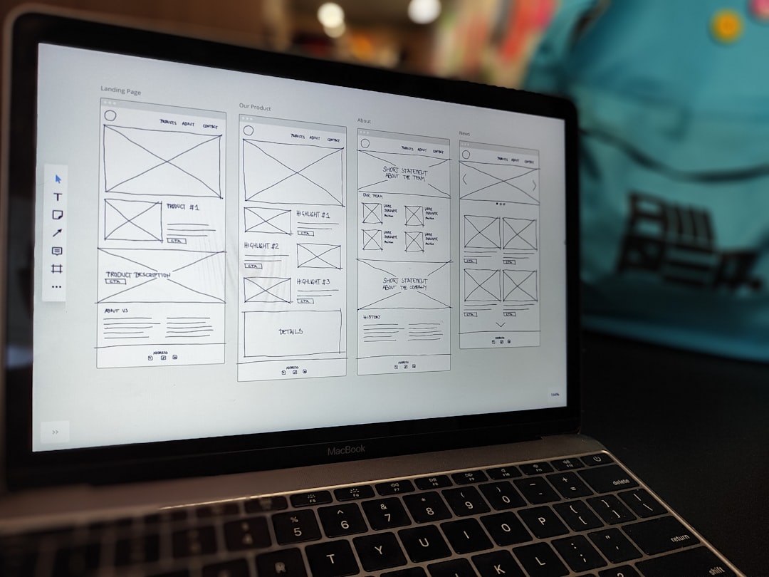 services-02 A website wireframe on a macbook screen on an office desk.